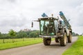 Crop sprayer on road with castle in background