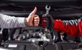 Anonymous man approving job of auto mechanic in workshop Royalty Free Stock Photo