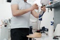 Crop unrecognizable craftsman adjusting and bending modern prosthetic leg at knee section Royalty Free Stock Photo