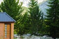 Crop view of guest house in the high mountain, wild Alpine nature background