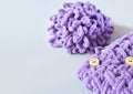 Crop view of knitted cozy baby blanket and a skein of violet yarn. knitting as hobby and relaxing leisure. anxiety reduction and Royalty Free Stock Photo