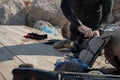 Crop view of scuba diver adult man on a seashore with spearfishing gear and freshly caught octopus Royalty Free Stock Photo