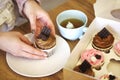 Crop woman with cupcake and cup of tea at home Royalty Free Stock Photo