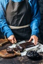 Crop woman cutting chocolate cake Royalty Free Stock Photo