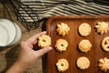 Crop woman taking cookies