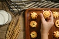 Crop woman taking cookies