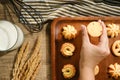 Crop woman taking cookies