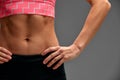 cropped close up body of fit woman wearing shorts and sport top showing slim beautiful stomach and abs in diet fitness Royalty Free Stock Photo