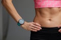 cropped close up body of fit woman wearing shorts and sport top showing slim beautiful stomach and abs in diet fitness Royalty Free Stock Photo