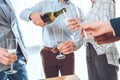 croped image of man in shirt pouring champagne