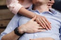 Croped photo of cheerful couple in summer clothes hugging while in the park. love story. They kiss and hug each other. selective