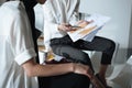 croped shot of fashion designers sitting on table