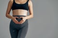 Croped shot of pregnant woman holding her hands in a heart shape on her belly. Pregnant belly with fingers heart symbol Royalty Free Stock Photo