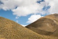 Abstact View of Tussock Grass Hills and Cloudy Blue Sky