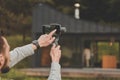 Cropped back view of businessman holding smartphone with steadycam