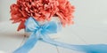 Cropped beautiful red peony flower bouquet in round box with blue sattin ribbon bow on white wooden background. Gift, greeting, Royalty Free Stock Photo