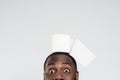 Cropped black man holds roll of toilet paper