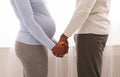 Cropped of black pregnant couple holding each other hands Royalty Free Stock Photo