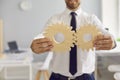 Cropped businessman holding 2 cogwheels that fit perfectly as metaphor for effective business system Royalty Free Stock Photo