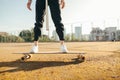 Cropped close photo, girl in stylish clothes and sneakers rides on a longboard. Girl`s feet stand on a skateboard. Background. Royalty Free Stock Photo