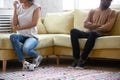 Cropped close up African American family ignoring each other.