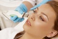 Beautiful woman getting ultrasound facial cleansing at beauty cl Royalty Free Stock Photo