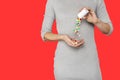 Cropped close up image of woman`s hand pours the pills out of the bottle isolated on red background Royalty Free Stock Photo