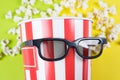 Cropped close up photo of behaving like a human confident nice trend bag with popcorn wearing black 3d specs isolated over vivid