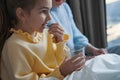 Well-behaved little girl taking medication for her sickness Royalty Free Stock Photo