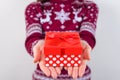 Cropped close up photo portrait of hands giving small dotted present to you isolated on gray background copy space