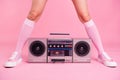 Cropped close up photo skinny perfect ideal she her lady legs opposite standing boom box play between teens hanging out