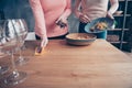 Cropped close up photo two people she her ladies arms hold dirty plates clean wash table wet rag holiday dishes kitchen Royalty Free Stock Photo