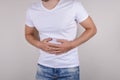 Cropped close up studio photo portrait of upset sad scared worried troubled gut having stomach ache disorder wear denim pants isol