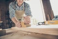 Cropped close-up view of his he nice attractive handsome guy skilled artisan builder polishing long board making new