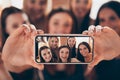 Cropped close-up view portrait of nice attractive lovely diverse charming cheerful glad ladies holding in hands device