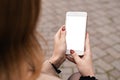 Cropped close up of woman hands holding and using mobile phone, smartphone with empty white screen Royalty Free Stock Photo