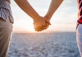 Loving lesbian couple holding hands on a beach at sunset Royalty Free Stock Photo