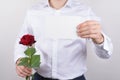 Cropped closeup photo portrait of handsome happy charming cheerful glad guy holding small post card in hands showing to you camera