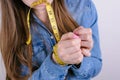 Cropped closeup photo portrait of sad frustrated helpless dependent addicted she her lady holding tied hands with yellow tape