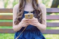 Cropped closeup photo of slim lovely pretty attractive teen lady user holding telephone in golden case in hands reading latest