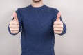 Cropped closeup photo studio portrait of glad positive nice guy giving double two thumbs up isolated grey background Royalty Free Stock Photo