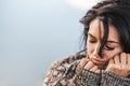 Cropped closeup shot of dreamy beautiful female wearing cozy sweater posing against the lake. Portrait of romantic female with Royalty Free Stock Photo