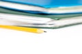 Cropped colorful folders with documents and bills and a yellow pencil on white table with copy space Royalty Free Stock Photo