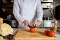 Cropped cook man in apron cutting vegetables Royalty Free Stock Photo