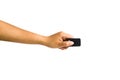 Cropped of a female hand holding black remote control isolated on white background include clipping path Royalty Free Stock Photo