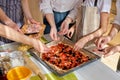 Cropped female hands adding ingredients to pizza, prepading tasty pizza for whole family Royalty Free Stock Photo