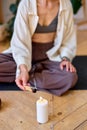 Cropped female use palo santo for meditation and aroma therapy at home