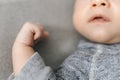 Cropped frame of newborn baby, nose, mouth and small hand in frame Royalty Free Stock Photo