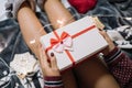 Cropped girl holding present over her nude calfs Royalty Free Stock Photo