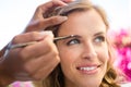 Cropped hand of beautician applying makeup to bride Royalty Free Stock Photo